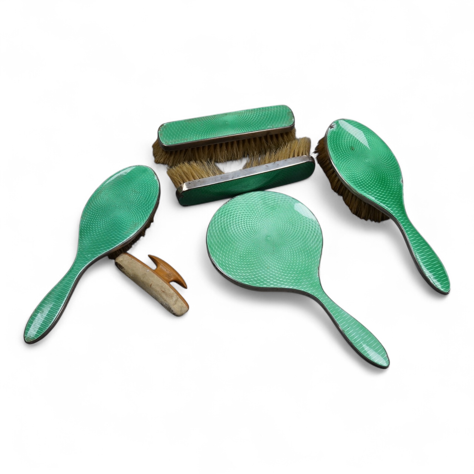 A George V silver and green guilloche enamel mounted five piece mirror and brush set, by William Neale & Son Ltd, Birmingham, 1931 (a.f.).